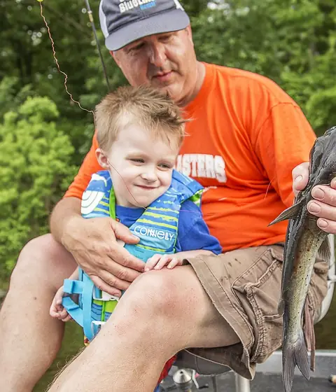 Father and child fishing together